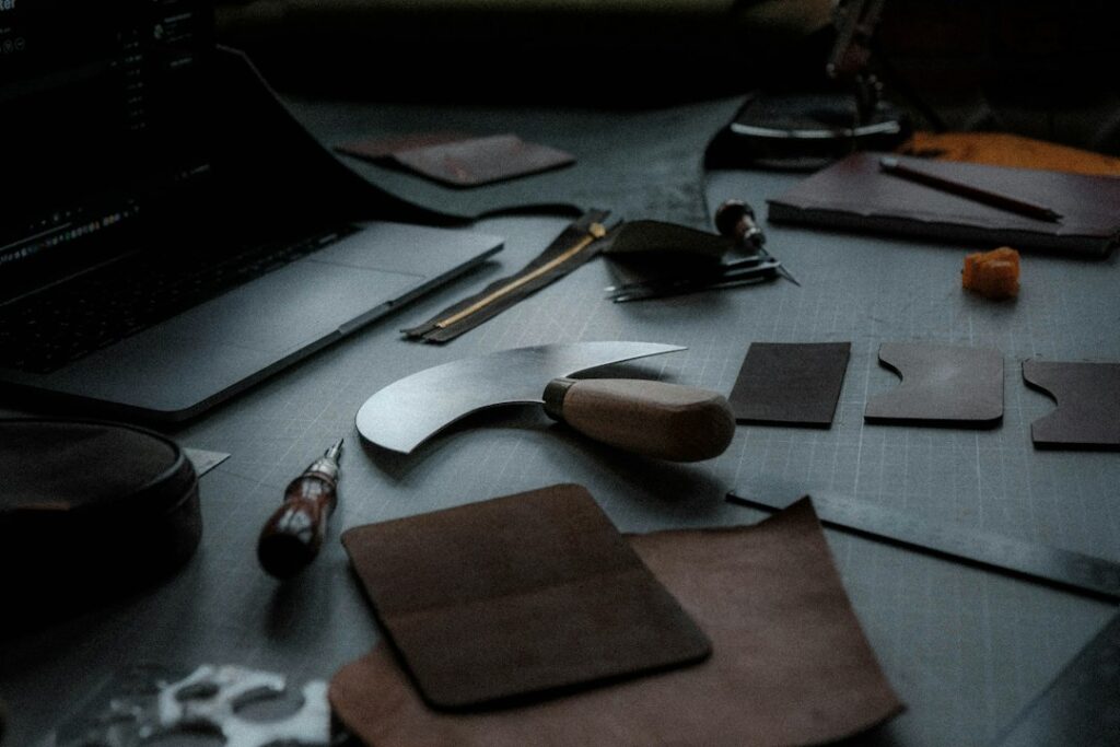 Leather artisan's workbench with tools and leather pieces